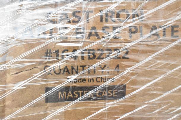 Cardboard box labeled "Cast Iron Table Base Plate, #164TB2222, Quantity: 4, Made in China," wrapped in plastic.