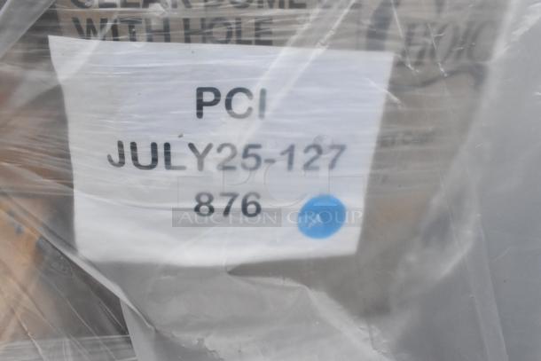 Plastic-wrapped pallet with label showing "PCI JULY25-127 876" and blue dot, containing new scratch and dent items.
