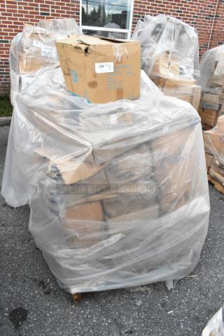 Pallet wrapped in plastic containing boxes marked "329" with scratch and dent items, including lids and wine glasses.