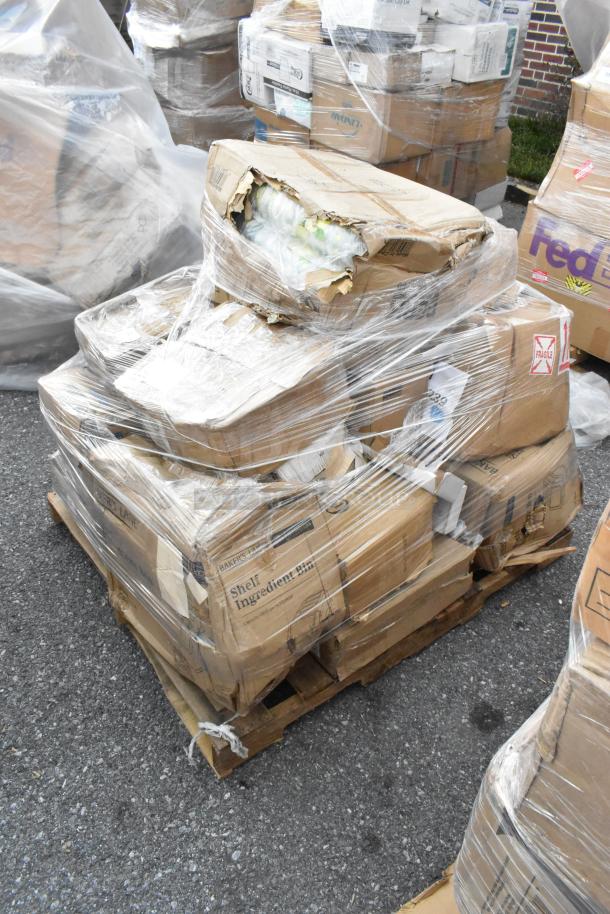 Pallet with 23 brand new scratch and dent items, including glasses and cookware, wrapped in plastic. Boxes show "fragile" and brand labels.
