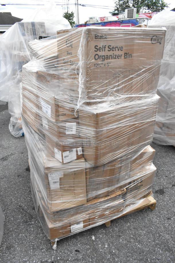 Pallet of brand new, scratch, and dent items wrapped in plastic, including labeled boxes for organizer bins.