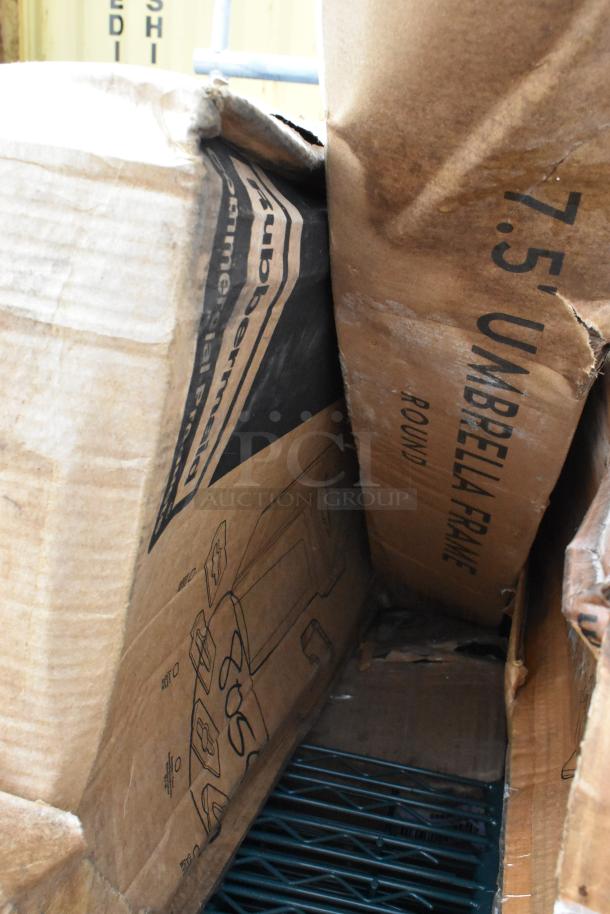 Cardboard boxes with "Rubbermaid" and "Umbrella Frame" labels, containing new scratch and dent items.