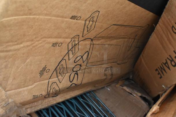 Cardboard box containing various brand new scratch and dent items including stanchions and shelves. Labels and diagrams visible.