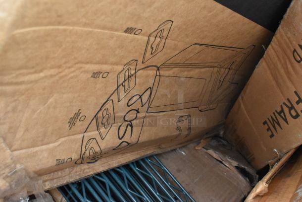 Cardboard box containing new stanchion and shelving items. Sketches are visible on the box. Items are scratch and dent.