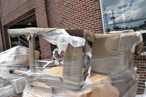 12 new scratch and dent chair frames, model 164CUSHMTLDG, dark gray vinyl, wrapped and stacked outside.