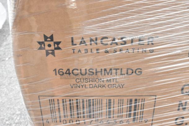 12 brand new scratch and dent Lancaster 164CUSHMTLDG chair frames in cushion metal vinyl dark gray, wrapped in packaging.