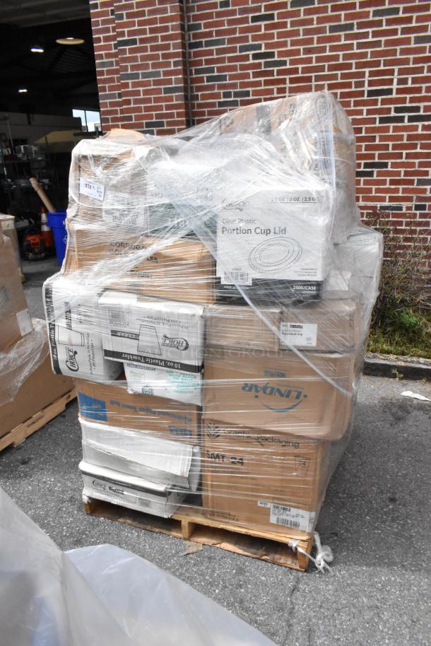Pallet of assorted brand new items, including towels, hot cups, gloves, and napkins, wrapped in plastic. Scratch and dent.