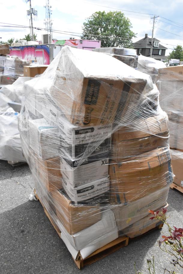 Plastic-wrapped pallet with assorted scratch and dent items including towels, hot cups, gloves, napkins, and foil.