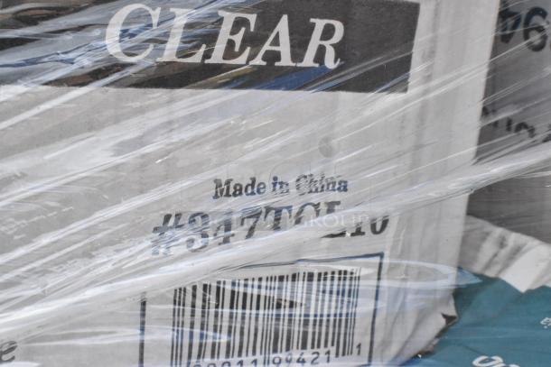 Box labeled "Made in China" and "#34-7TCL10" under clear plastic wrap, part of mixed lot including towels and more.