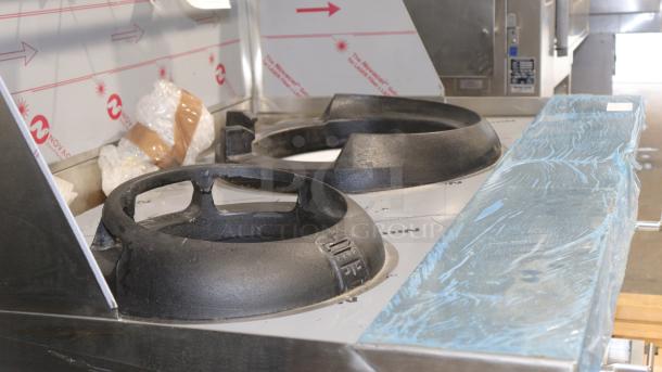 Brand new Town Y-2-SS-N two-chamber natural gas wok range, protective film intact, featuring cast iron burners.