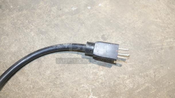 Power cord for STAKOL 2200W Commercial Ice Cream Machine, model EP23791, shown on a concrete surface.
