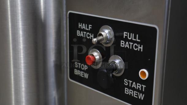 American Metal Ware 7776E coffee urn control panel, showing half/full batch toggle, stop, and start brew buttons.
