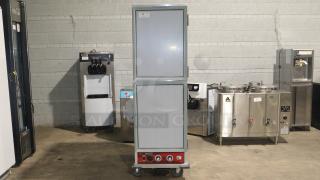 Avantco HPI-1836 heated holding cabinet, clear door, 120V, features temperature controls, on wheels for mobility, excellent condition.