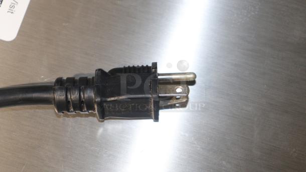 Close-up of a power plug for Avantco HPI-1836 holding/proofing cabinet, showing a three-prong connector on a metallic surface.