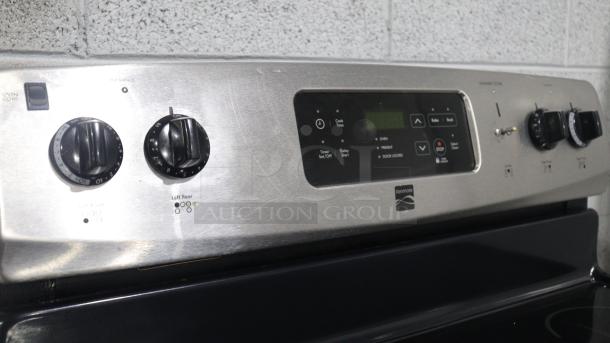 Kenmore stove model C648433, stainless steel finish, featuring control knobs and digital display for cooking settings.