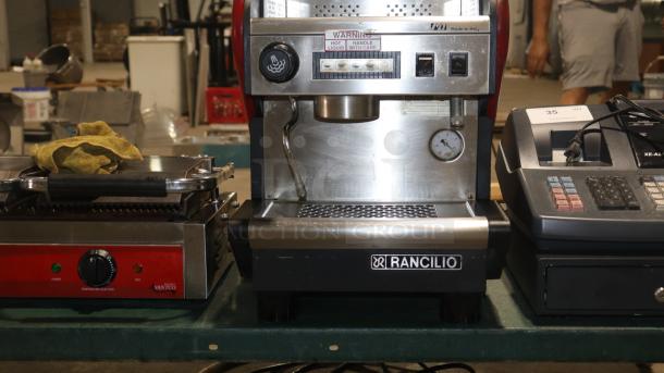 RANCILIO S27 commercial espresso machine, stainless steel, 1 group, automatic, 115V, labeled warning: "hot liquid, handle with care."