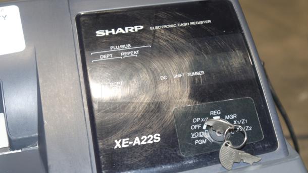 Sharp XE-A22S cash register in used condition, featuring control panel with keys. Dimensions: 14x14x12 inches.
