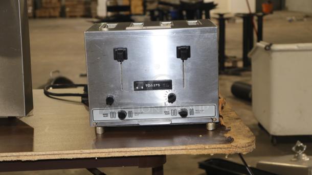 TOASTSWELL NBT4-L 4-slice toaster, stainless steel, well-used condition, adjustable settings, visible logo and dials.