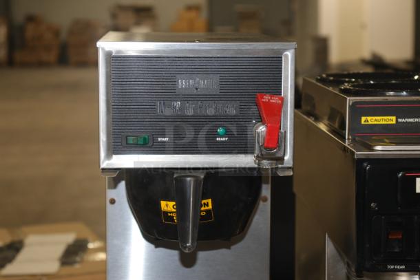 Brewmatic M-90 coffee maker with stainless steel and black design. Features include start and ready indicators, red hot water lever.