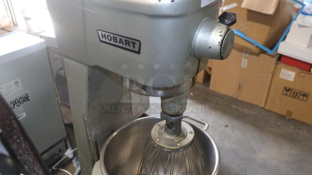 Hobart D300 30 Qt dough mixer, silver finish, used condition with visible wear. Model label visible, ideal for bakery use.