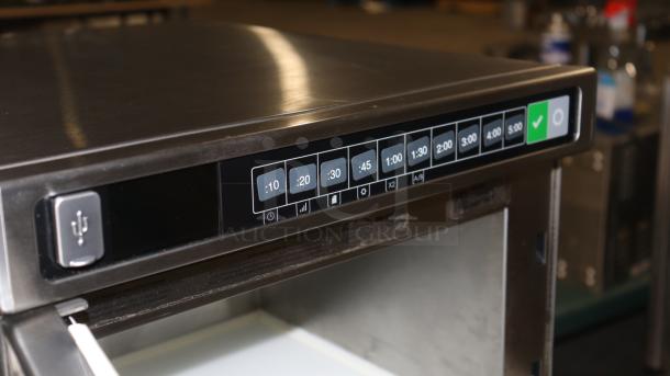 Amana HDC1015 heavy-duty stainless steel commercial microwave, 1000W, push button controls, digital timer visible.