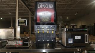 Curtis CAFEPC4CS10000, 4 Flavor Primo Cappuccino Dispenser in good condition, featuring flavor selection buttons and branding.
