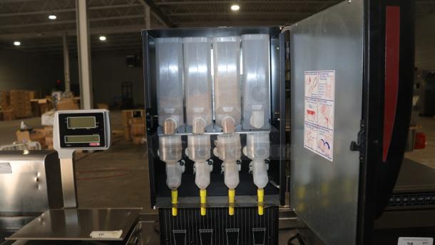 Curtis CAFEPC4CS10000, 4 flavor Primo cappuccino dispenser, open view showing mixing hoppers and dispensing nozzles.