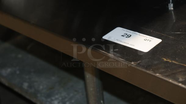 61" stainless steel counter for baking or storage, slight surface wear, auction tag indicating item number 29.