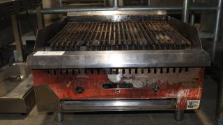 Avantco 2 burner gas grill with stainless steel finish, showing wear and discoloration. Features manual controls and label with model info.