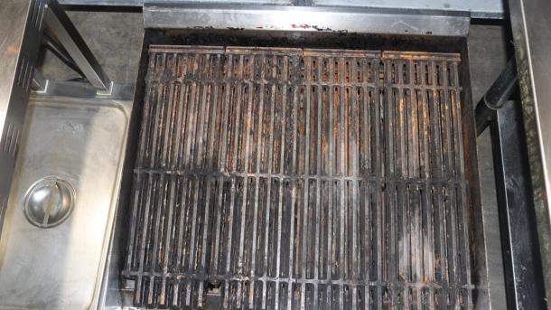 Avantco 2 burner gas grill with stainless steel construction. Features weathered grates and built-in drip tray.