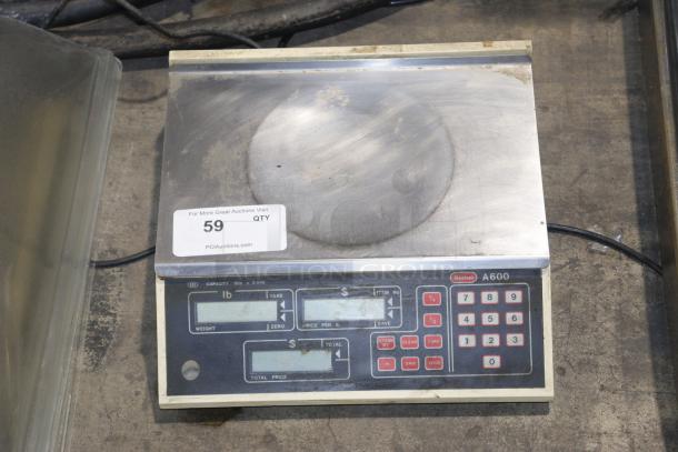 Berkel A600 scale for deli/produce with keypad, display, and weight capacity marking. Shows signs of wear. Auction label visible.