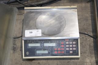 Berkel A600 scale for deli/produce with keypad, display, and weight capacity marking. Shows signs of wear. Auction label visible.