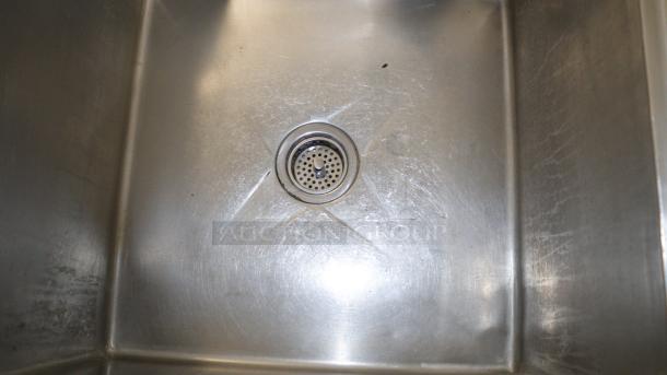 50" stainless-steel sink in used condition, featuring a drain in the center. Ideal for baking, cooking, or storing.
