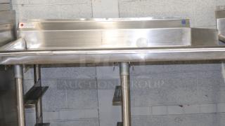 48'' stainless steel counter for baking or storage, industrial-grade, minor wear, visible manufacturer label, robust construction.