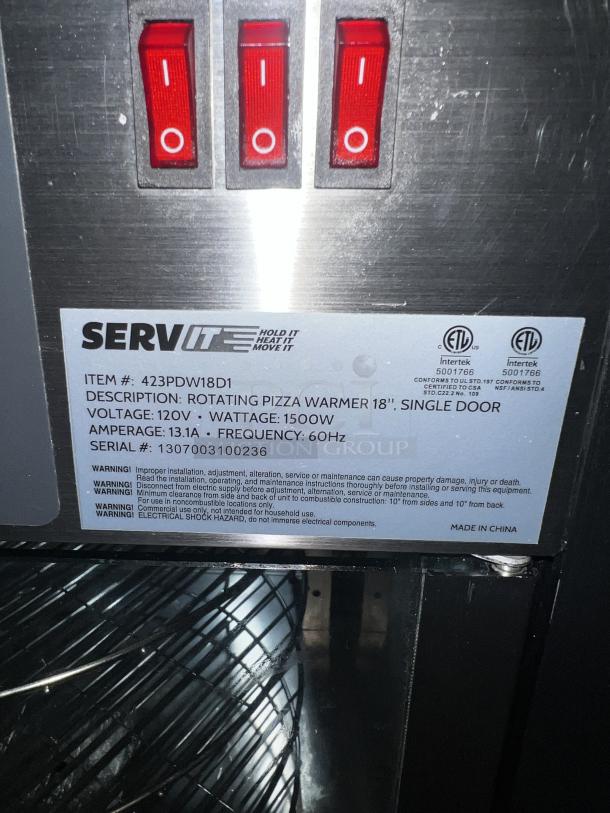 SERVIT 423PDW18D1 18" pizza warmer; rotating, single door; 120V; 1500W; label with serial 1307003100236; good condition.
