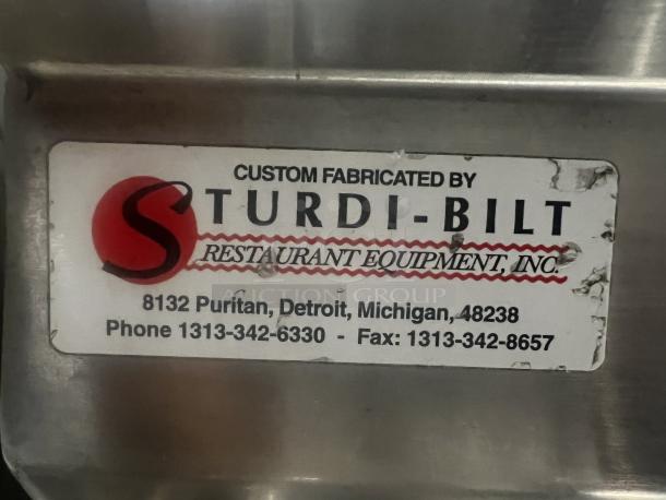 Sturdi-Bilt Deluxe Dishtable, 16-gauge stainless steel, features 3 bun pan rack. Label indicates custom fabrication details.