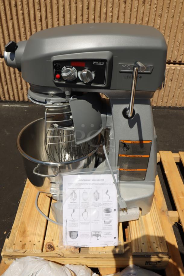 Brand new Hobart HL200-1STD 20 Qt. stand mixer with accessories. Cracked plastic cover. Includes stainless steel bowl.