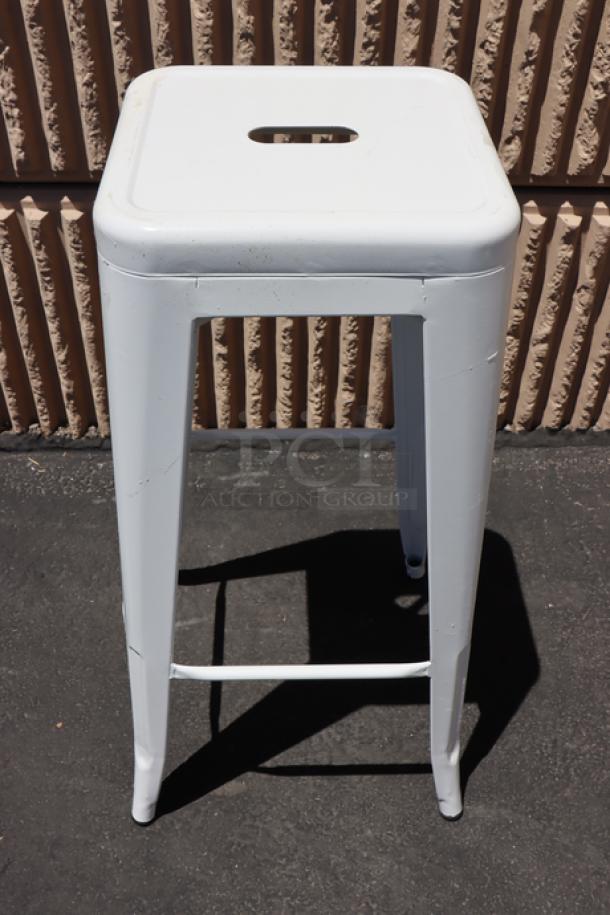 Lancaster Table & Seating Alloy Pearl White outdoor backless barstool, model 164BMBKLSWHT, minor scratches visible.