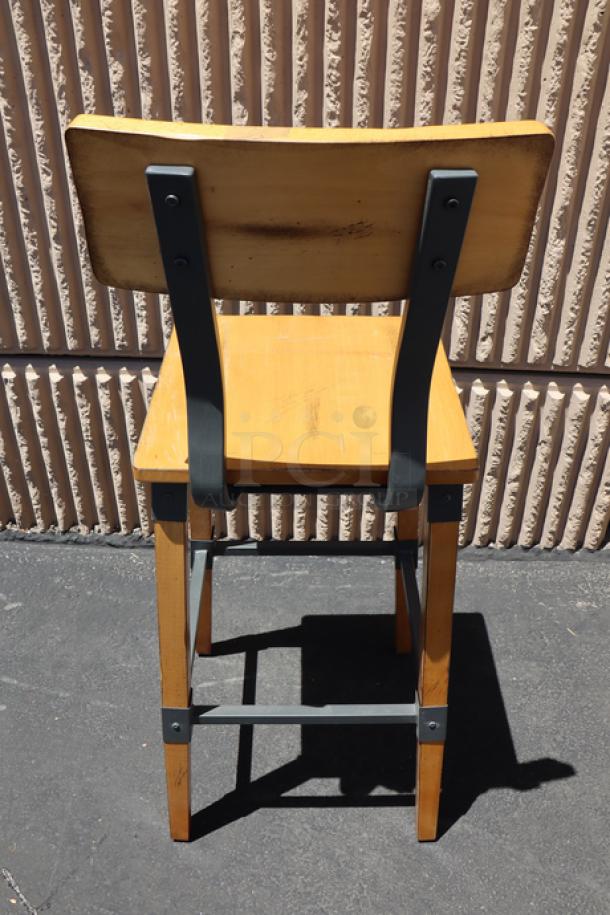 Brand new Lancaster Table & Seating industrial bar stool, model 164BINDNATAN, with honey maple finish, metal frame.
