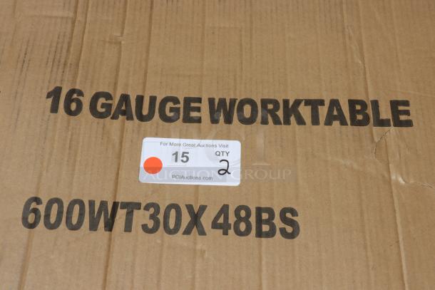 Cardboard box labeled "16 Gauge Worktable" and "600WT30X48BS" for Regency stainless steel work table; auction label indicates quantity 2.