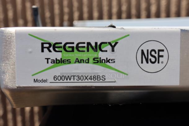 Regency stainless steel work table model 600WT30X48BS, new condition, 16-gauge 304 steel, 4" backsplash, NSF certified.