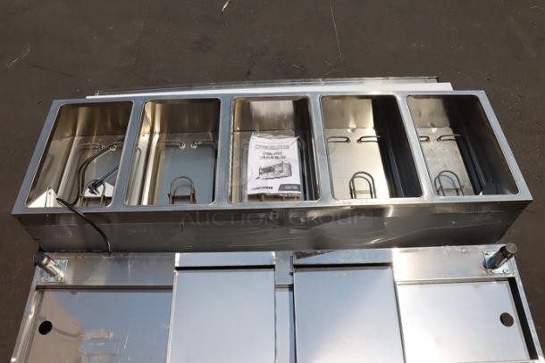 Brand new ServIt five pan electric steam table with partially enclosed base, model 423EST5WOPB. Superficial dents visible.
