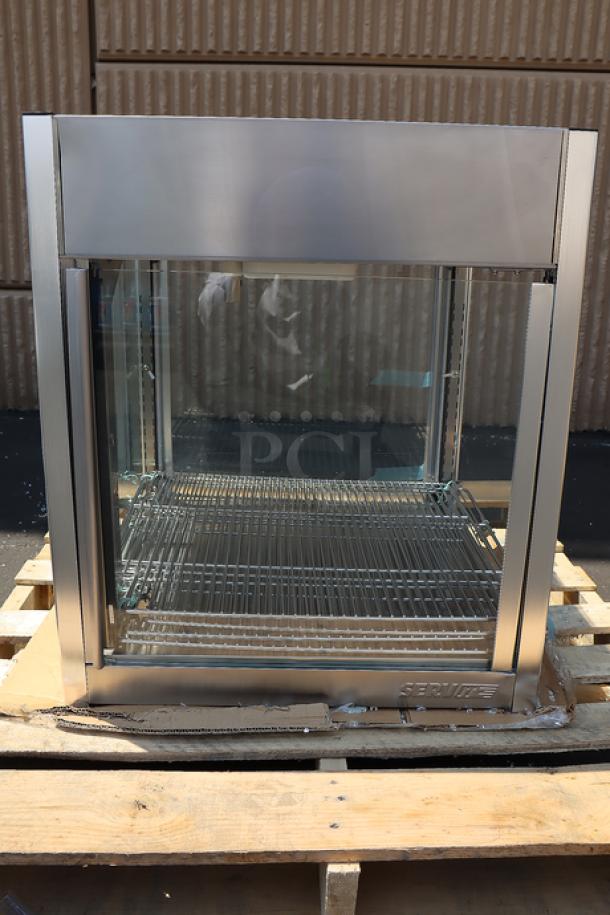 ServIt PDW18D2S 18" countertop display warmer with 4 shelves. Missing glass on one side, minor denting. Both doors intact.