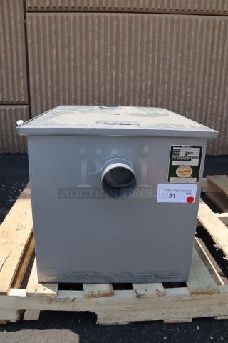 Regency 600GT25 grease trap, 50 lb. capacity, 25 GPM, 3" non-threaded connections, superficial scuffs, appears complete.