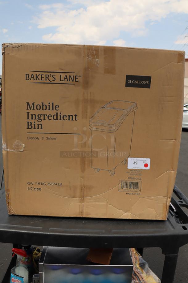 Brand new Baker's Lane 21-gallon mobile ingredient bin, model 176BIN21GL, with slant top and sliding lid. Original packaging stained.