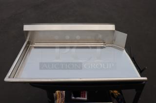 Regency 600CDT48L 4' Clean Dish Table with left drainboard, stainless steel, minor denting, bent backsplash corner.