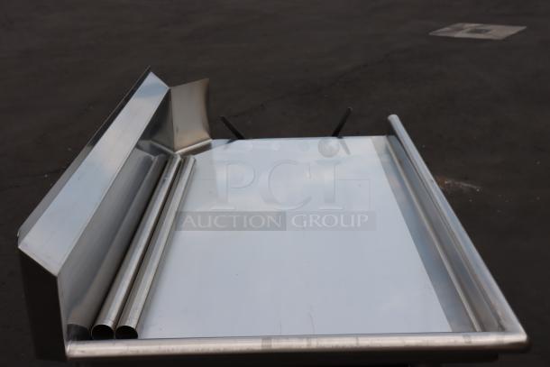 Regency 600CDT48L 4' clean dish table with left drainboard, stainless steel legs; minor dent, bent backsplash corner. Brand new.
