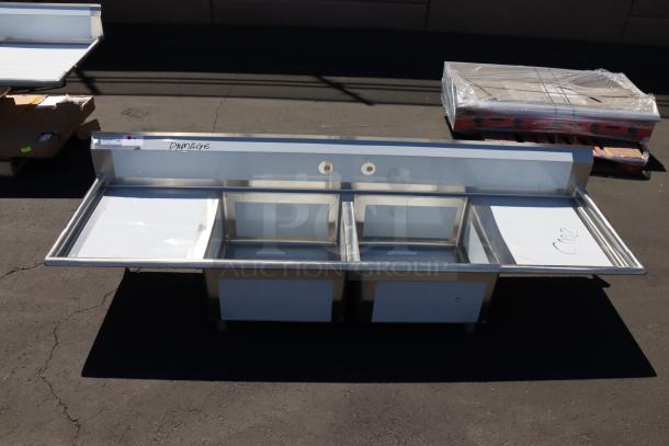 Regency 600S22323224 96" stainless steel sink, 16 gauge, two compartments, galvanized legs, minor dents. Labels note damage.