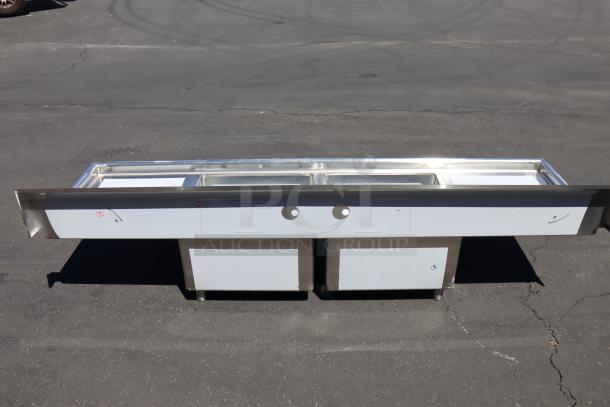 Regency 600S22323224 stainless steel two compartment sink, 96", with galvanized legs and two drainboards. New, minor dings.
