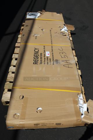Regency 600T3096G stainless steel work table in damaged box on pallet. Box may be missing parts; includes scratches/dents.